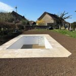 Réalisation Piscine avec terrasse béton et pose de Margelle et carreaux en gré cérame.